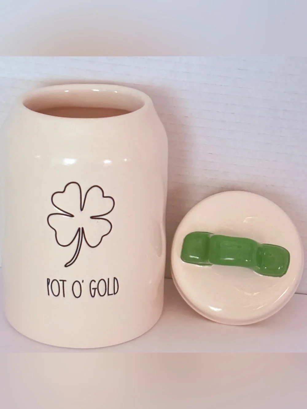 Rae Dunn off White Ceramic 'POT O’GOLD’ Canister with Green Handle covered lid.